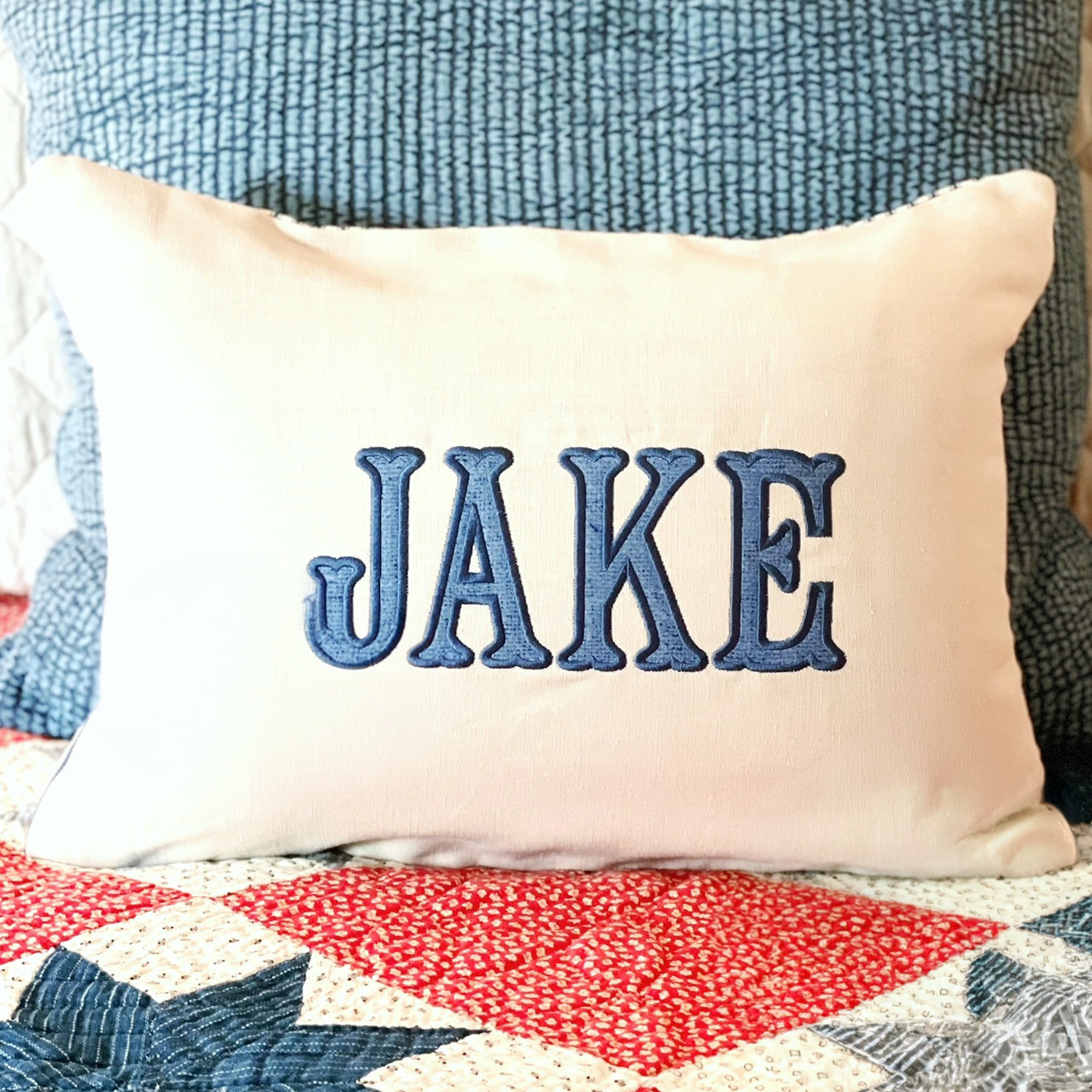 PIPED PILLOW WITH APPLIQUED